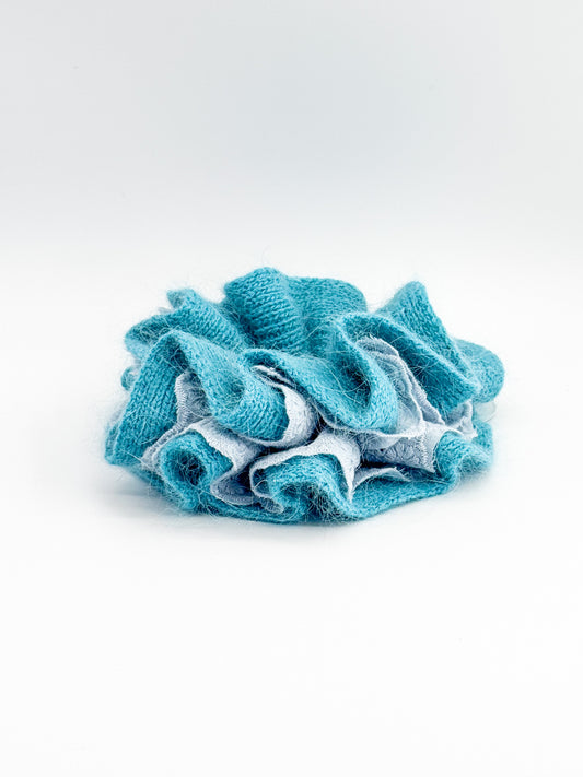 Blue knit and lace scrunchie on a white background