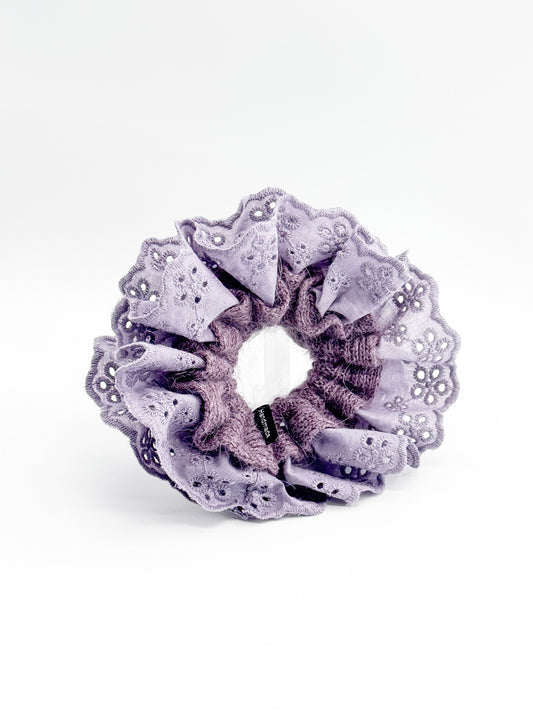 Purple scrunchie with lace details on a white background