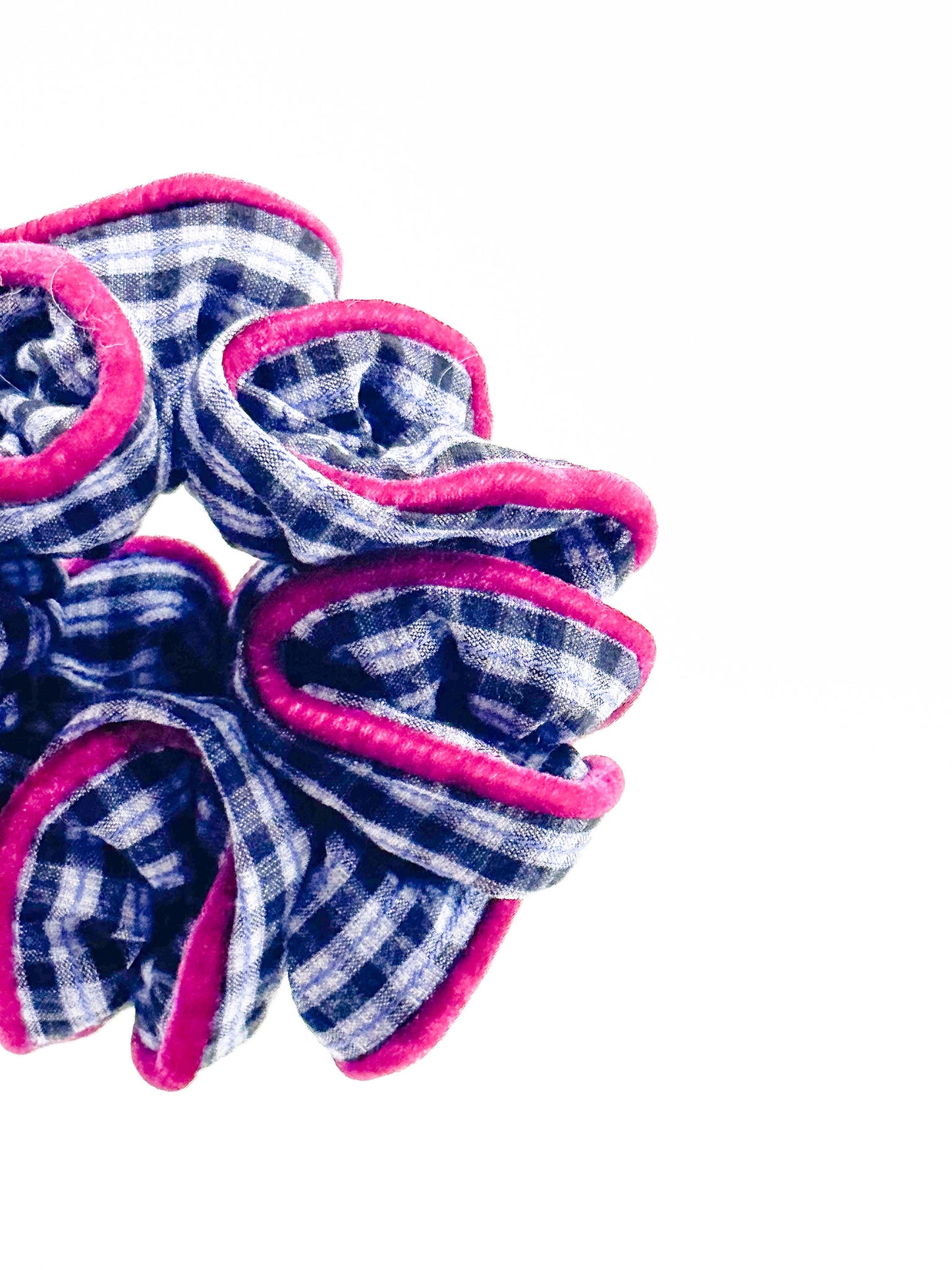  blue and pink checkered scrunchie on a white background