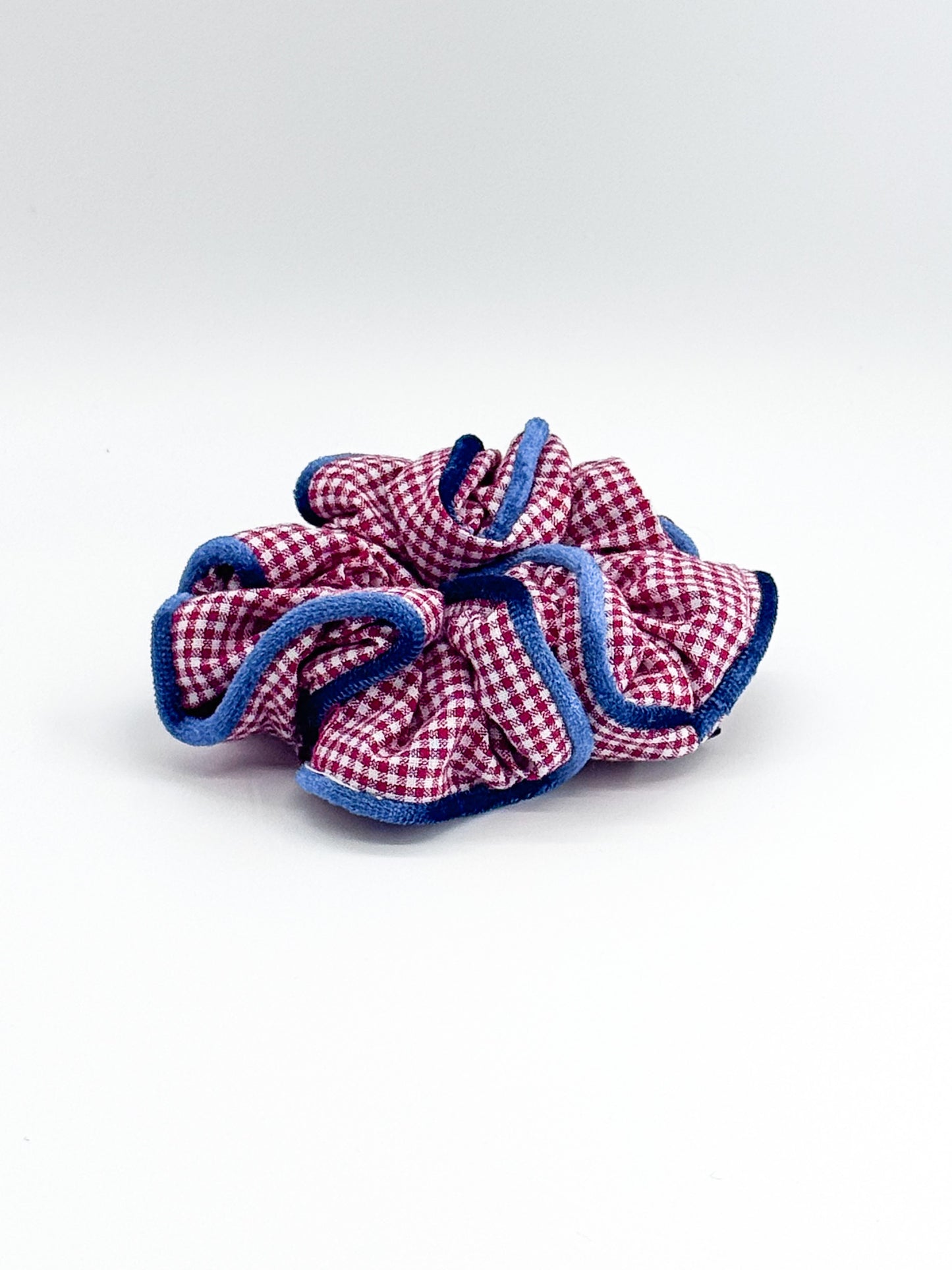 Red and blue checkered scrunchie on a white background