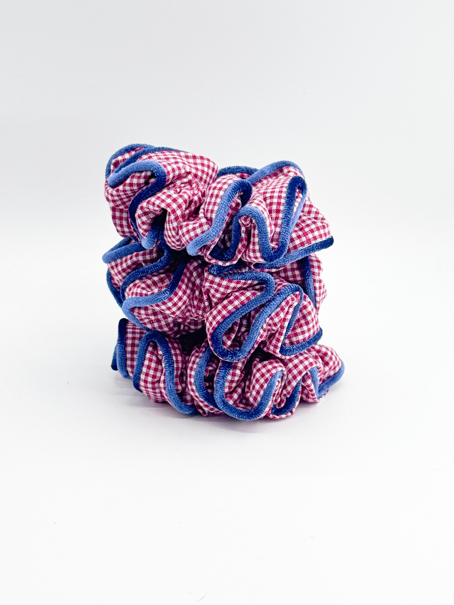 Red and blue checkered scrunchie on a white background