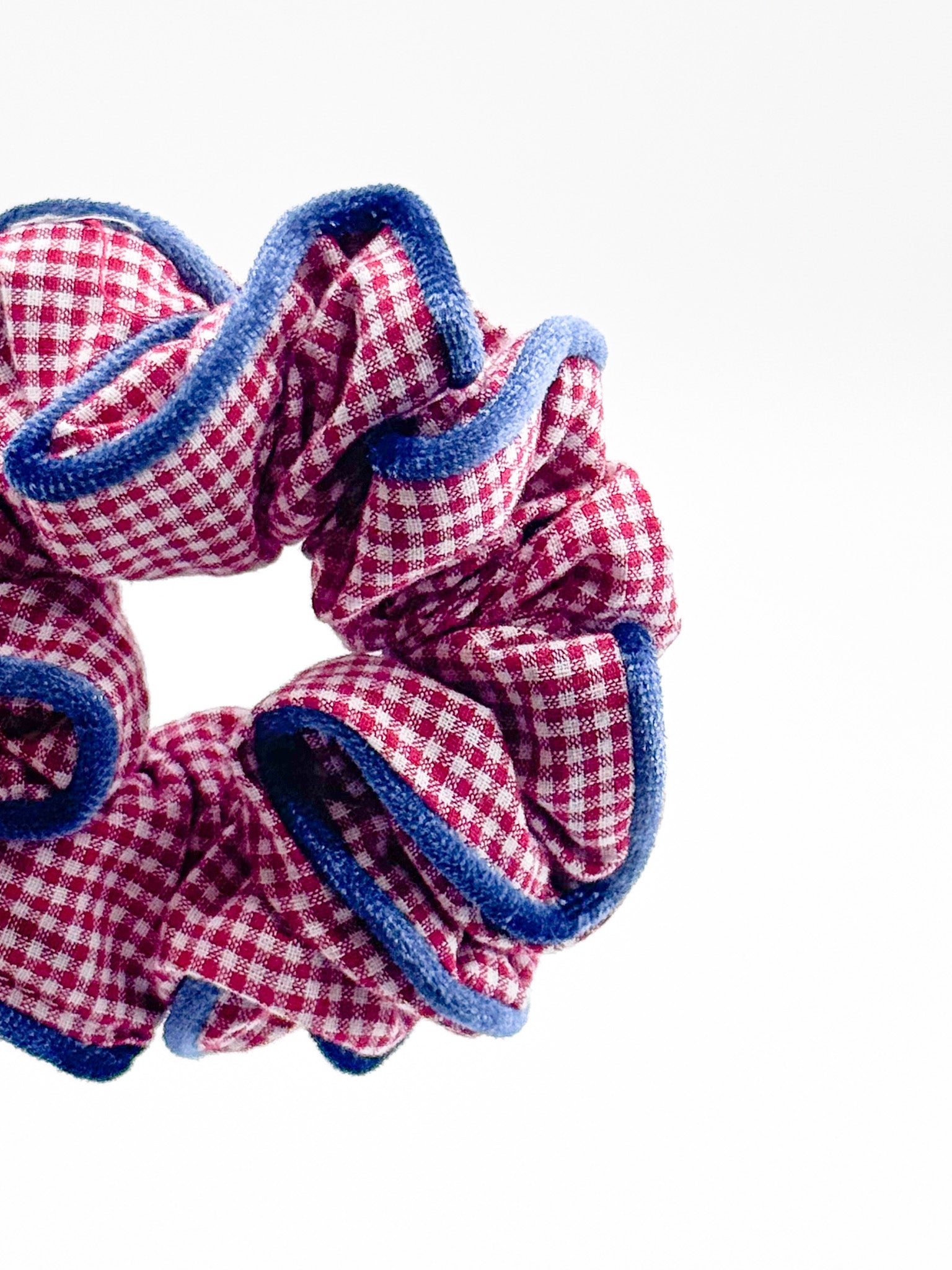 Red and blue checkered scrunchie on a white background