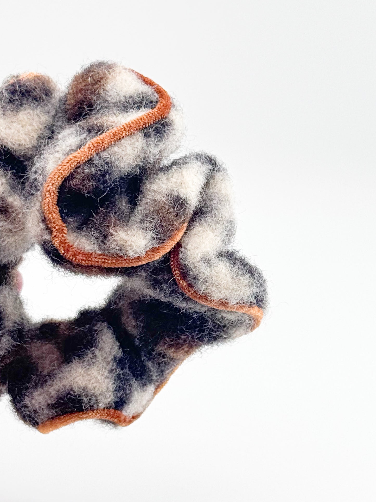 A leopard print with orange trim on a white background