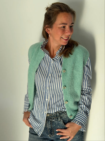 Leopard print scrunchie on a wrist against a white background