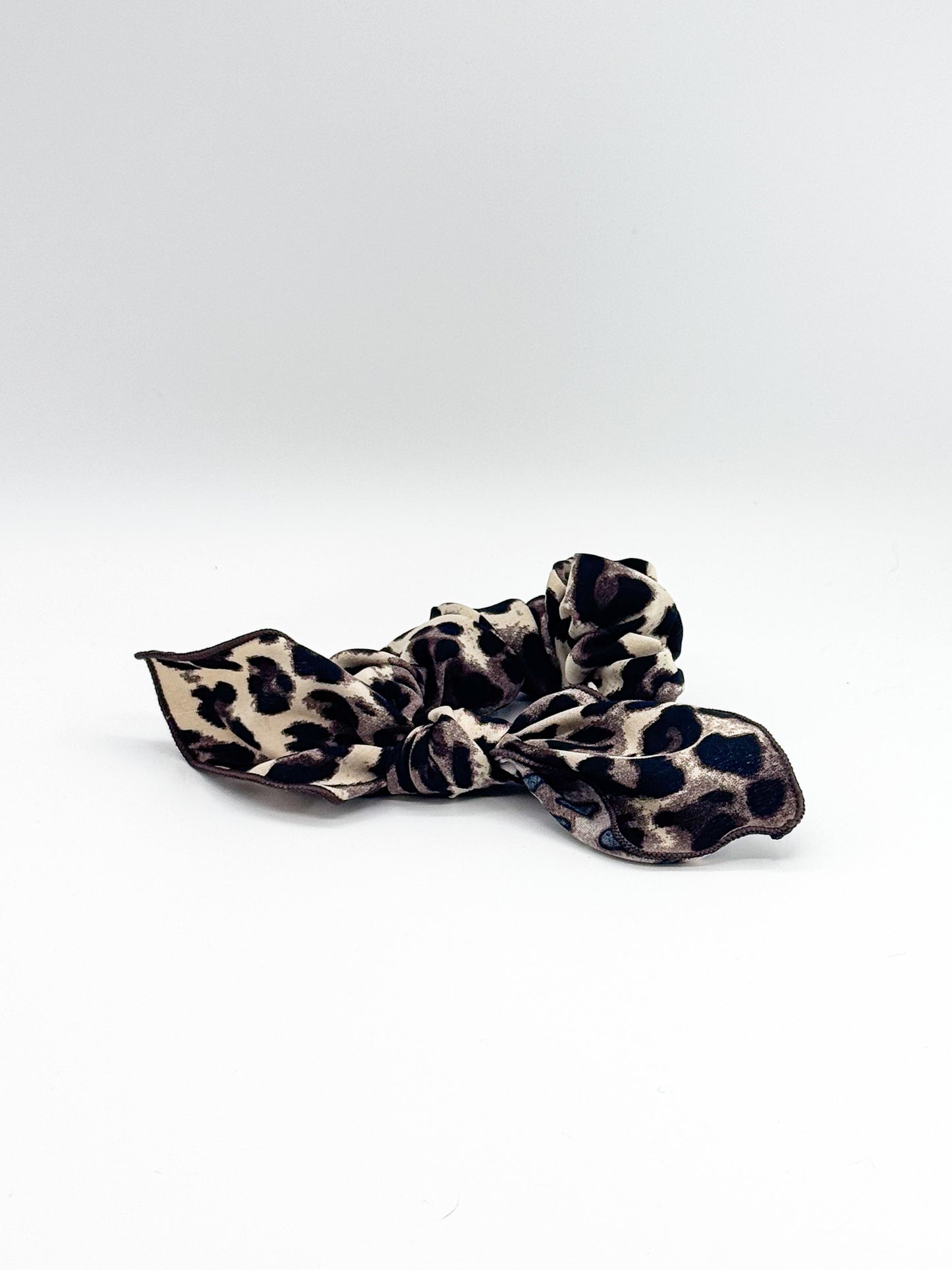 Leopard print hair scrunchie on a white background