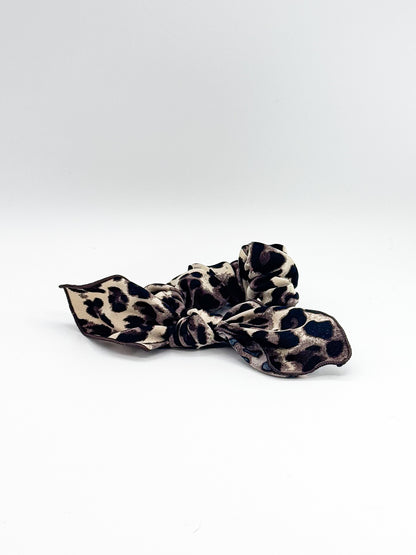 Leopard print hair scrunchie on a white background