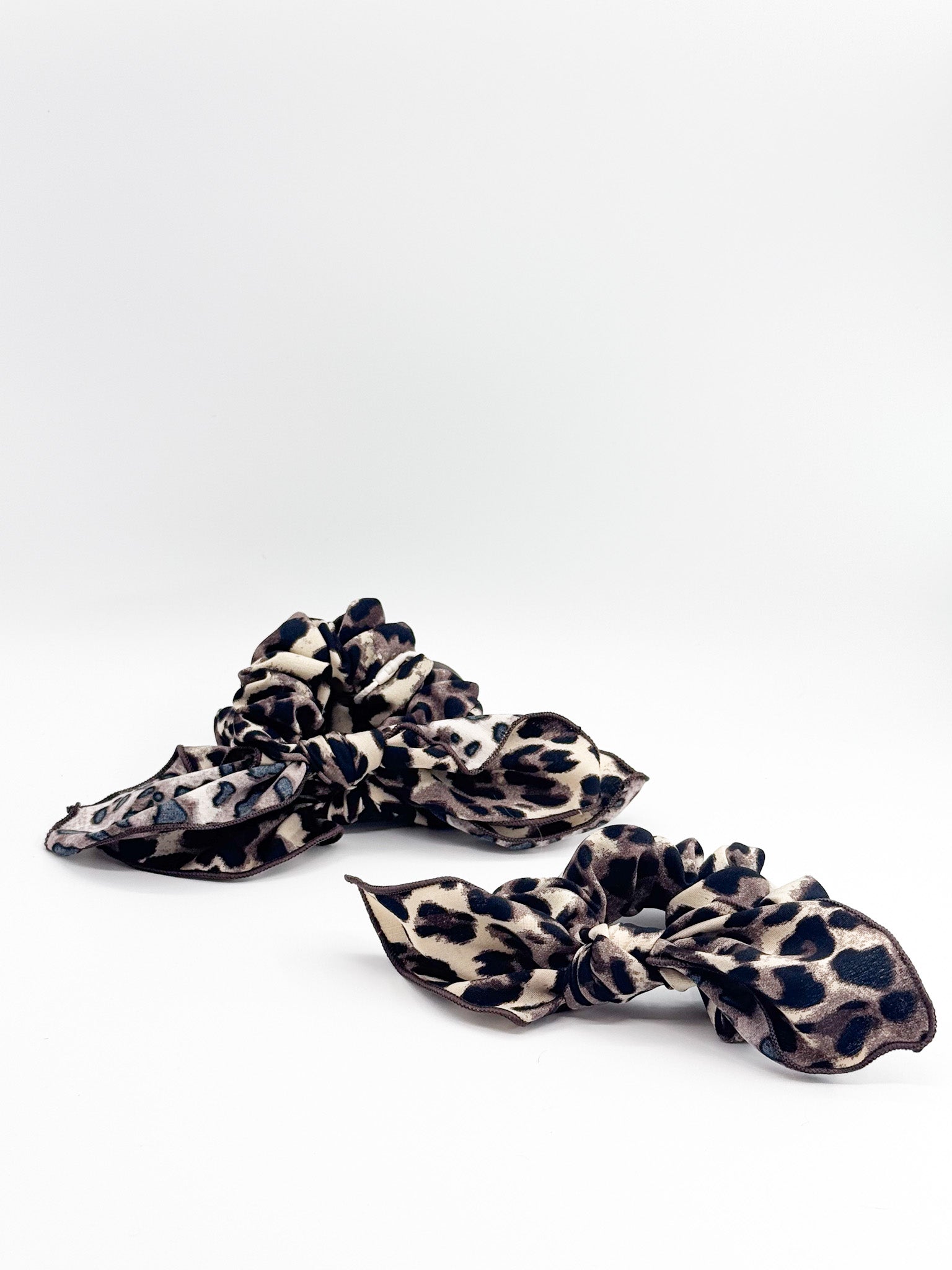 A set of  leopard print scrunchies on a white background