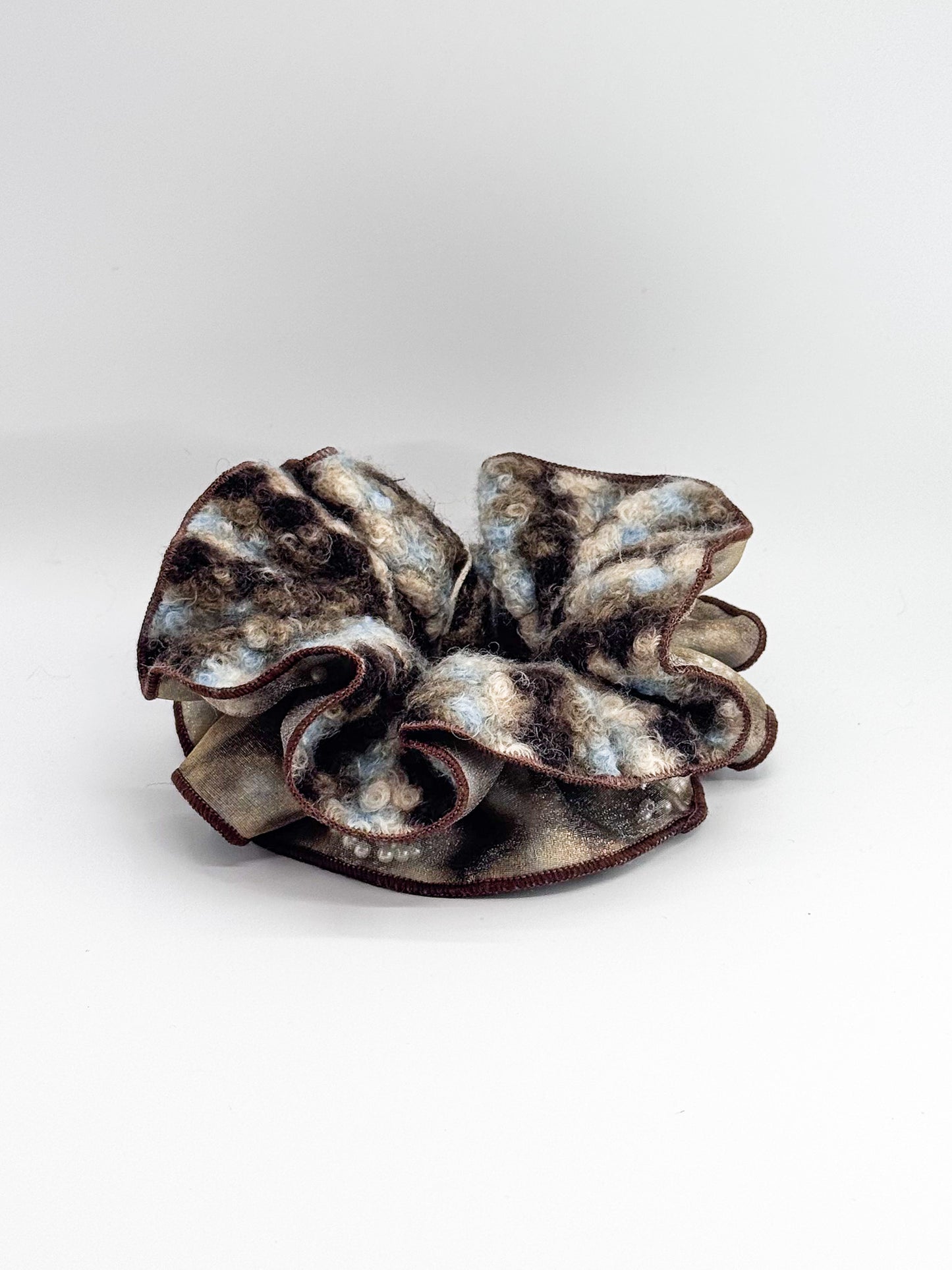 Brown and gray textured hair scrunchie on a white background