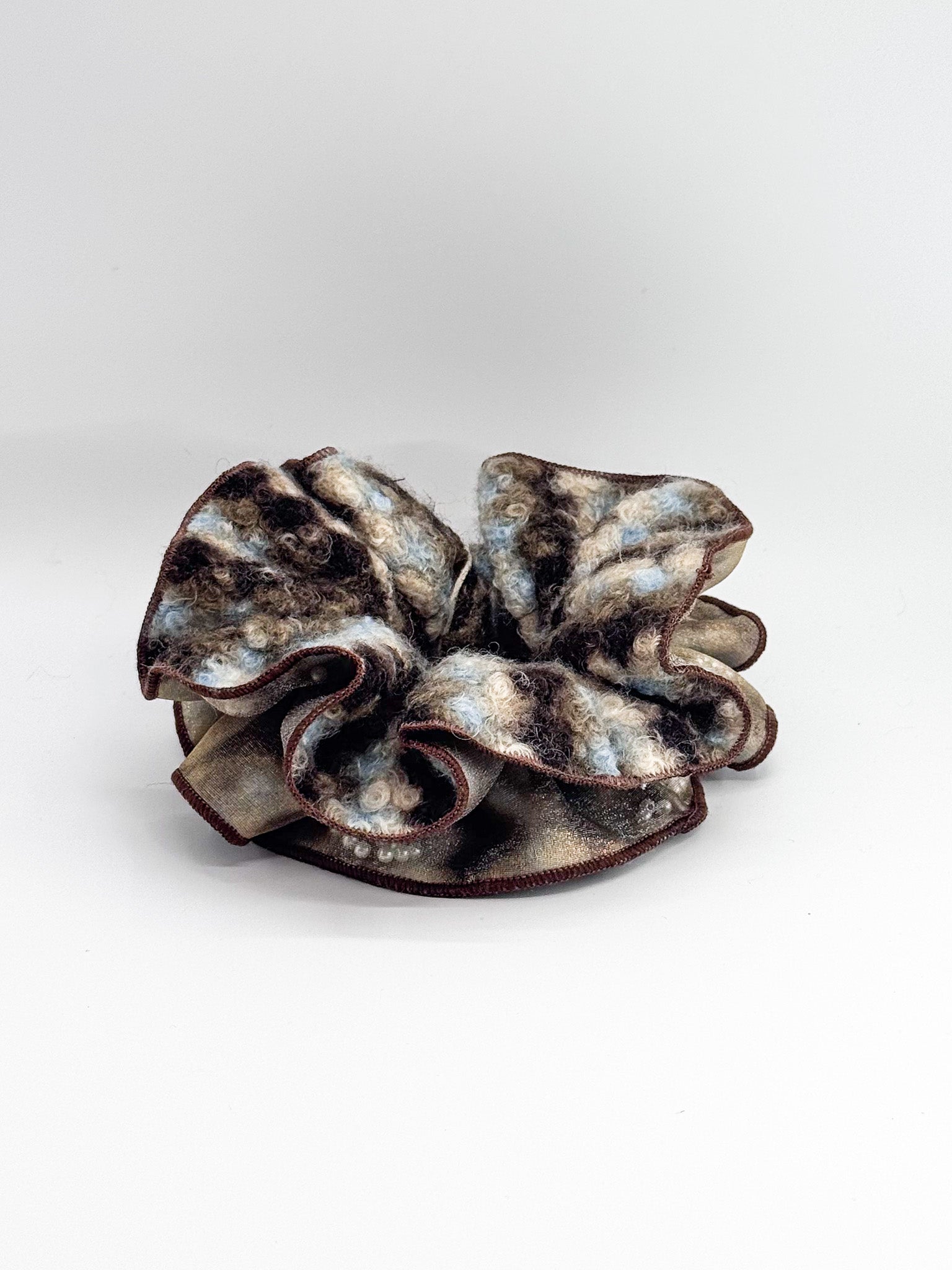 Brown and gray textured hair scrunchie on a white background