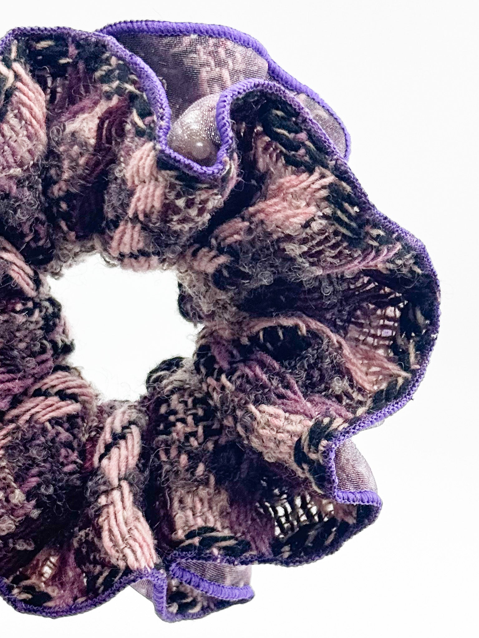 Scrunchie with purple trim on a white background