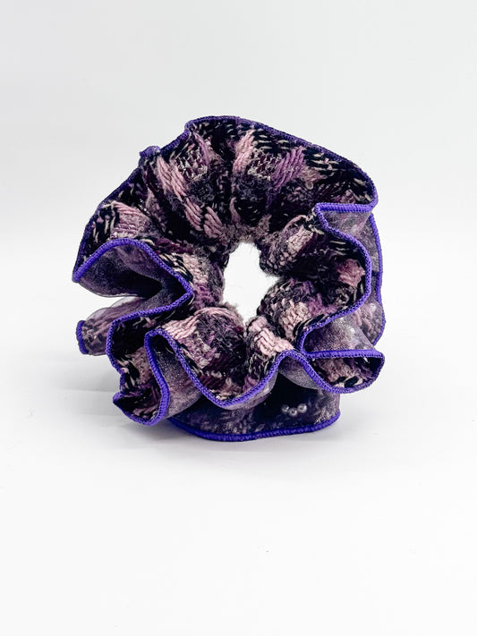 Purple and black patterned scrunchie on a white background