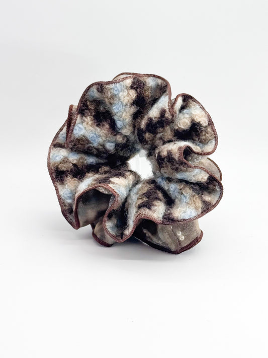 Brown knit scrunchie on a white background