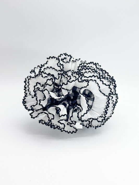 Black and white checked pattern scrunchie  on a white background