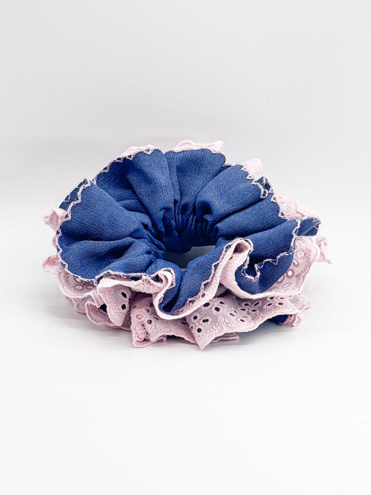 Blue scrunchie with pink lace on a white background