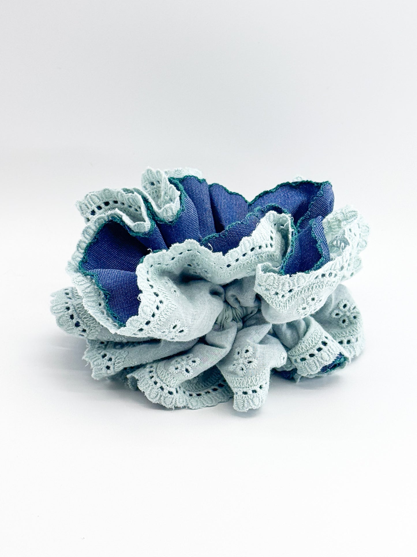 Blue and white lace scrunchie on a white background